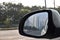 View of skyscrapers in rear-view mirror of car in Noida