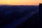 View of the sleeping city of Togliatti and a strip of dawn sky from a height of the 16th floor of a residential building.