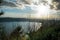 View of the slopes, forests and hills of Lake Albano in a cloudy sunset.