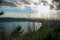 View of the slopes, forests and hills of Lake Albano in a cloudy sunset.