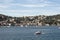 View of a small boat on Bosphorus and Bebek neighborhood on European side of Istanbul. It is a sunny summer day.