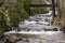 View of small cascading waterfalls under a bridge