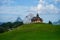 View of a small chapel in front of a Kleiner Mythen mountain in Muotathal, Switzerland