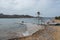 View of the small, concrete pier next to a sandy beach, Antiparos Island, Greece