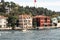 View of a small fishing boat on Bosphorus and historical and traditional mansions in Kandilli area of Asian side of Istanbul.