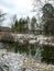 view of a small forest river near a pine forest in the Middle Urals at the beginning of winter