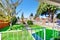 View of small front yard with narrow concrete walkway and green lawn.