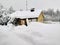 View of a small house after a heavy snowstorm