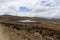 View of small lagoons, yellow meadows, rocks and some vegetation in the morning, on the way to Tecllo Lagoon