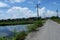 View of the small ricefield beside the main road under the clear sky