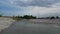 View of a small river with sandy banks under a cloudy sky