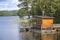 View of a small sauna by a lake, on a jetty