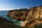 View of a small secluded beach surrounded by cliffs in Algarve