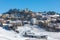 View of small town on the hill covered in snow in Italy.