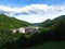 View of small town of Zelezniki in Selska dolina in Gorenjska region of Slovenia surrounded by forest covered hills