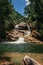 View of small waterfall lagoon in the middle of the forest at the Itatiaia Park.