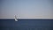 View of small yacht boat sailing in calm open sea in Montenegro