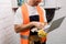 View of smiling electrician holding glove