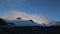 View of the snow-capped mountains in the shade and the valley with small pebbles. Andreev.