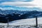 View from a snow coveread meadow to the Swiss mountain ridges