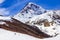 View of the snow-covered Kazbek, a group of skiers rises to the top