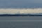 View on snow covered mountain form merchant vessel approaching Vancouver, British Columbia  from Pacific ocean under heavy rainfal