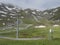 View on snow spotted mountain slopes at Mittelstation with Stubaier Gletscher gondola lift at Stubai Glacier in Tyrol