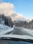 view of snowed road in mountains range car travel concept