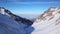 View from the snowy gorge in the mountains to the clouds and the city smog.