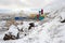 View of a snowy hillside and a gas engine power station