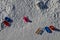 View of a snowy plain with wooden park benches and several sleighs and plastic children`s bobbing the joy of a winter sunny day un