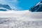 View of snowy slope on the way to the pass in the mountains. Atmospheric mountain landscape with glacier on rocky hill. Awesome