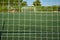view of a soccer field behind the net of a goal