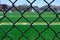 View of soccer field through chain link fence