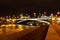 View of Sofiyskaya Embankment of Moskva river and Bolshoy Kamenny Bridge with night illumination. City landscape
