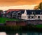 View on some modern houses with water and grass at sunset in the city Leerdam the Netherlands, typical dutch neighborhood