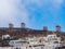 A view of some white houses of Chora of Amorgos, with the windmills above them