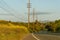 View of southern California highway lined by electrical  utility poles.