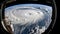 View from the space station of hurricane on planet Earth. Hurricane manifests as spiral formed by powerful clouds and stormy