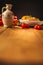 A view of a spelled dish on wooden background with some ingredients around: carrots, peppers, tomatos, parsley and oil