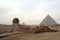 View of the Sphinx With the Great Pyramid in Background on The Giza Complex