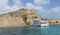 View of Spinalonga fortress and tourist cruise boat, Crete, Greece