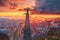 View of the spire of a skyscraper and a panorama of the urban landscape in the morning at sunrise with clouds and fog