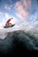 View of sports guy riding wave doing jumps and tricks on the surf style wakeboard