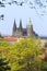 View on the spring Prague gothic Castle with the green Nature and flowering Trees