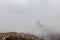 View of St. Francis papal church in Assisi Umbria, Italy in the middle of lifting morning fog