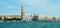 View of St Mark`s bell tower and the Doge`s Palace taken from vaporetto on the Venice Lagoon, Italy