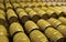 View of stacked casks at a whisky distillery in a row under the light