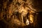 View of stalactites and stalagmites in an underground cavern - Postojna cave, Slovenia