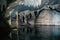 View of the stalactites and walls of a cave reflecting on the water